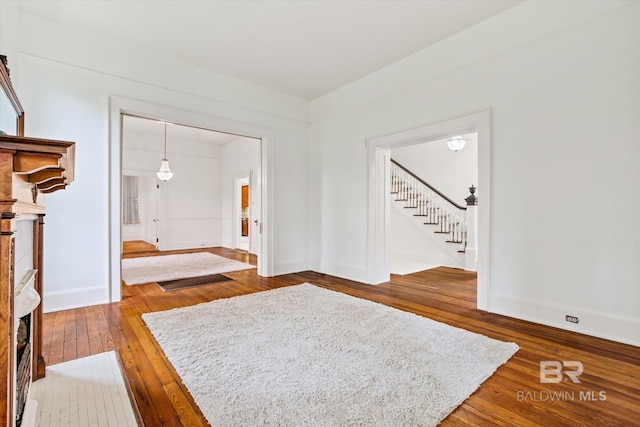 entryway with stairs, baseboards, and hardwood / wood-style flooring
