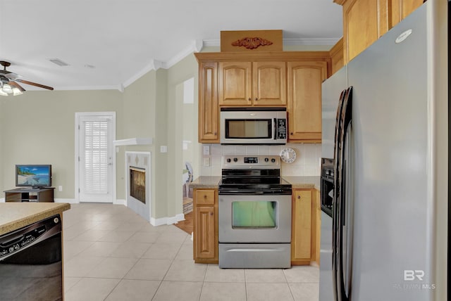 kitchen with decorative backsplash, ornamental molding, stainless steel appliances, ceiling fan, and light tile patterned flooring