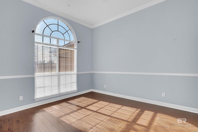 empty room with hardwood / wood-style floors and ornamental molding