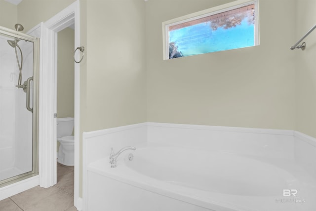 bathroom with tile patterned floors, toilet, and shower with separate bathtub