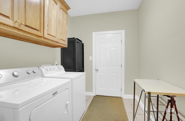 laundry area featuring light tile patterned flooring, cabinets, and independent washer and dryer