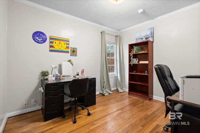 office space with ornamental molding, a textured ceiling, and light wood-type flooring