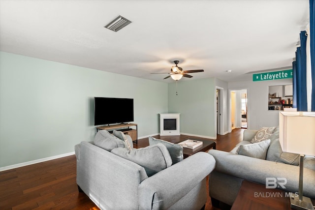 living room featuring dark hardwood / wood-style flooring and ceiling fan