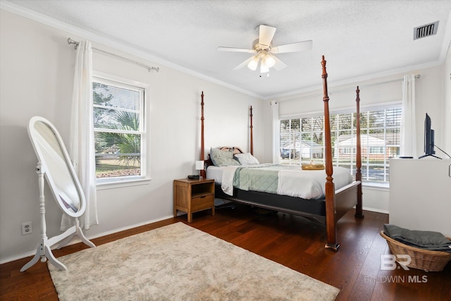 bedroom with ornamental molding, dark hardwood / wood-style floors, and a textured ceiling