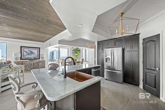 29235 Perdido Beach Blvd Unit 703, Orange Beach, AL 36561 - kitchen with appliances with stainless steel finishes, ornamental molding, plenty of natural light, a sink, and light stone counters