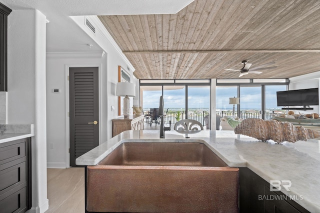 29235 Perdido Beach Blvd Unit 703, Orange Beach, AL 36561 - kitchen with a sink, ceiling fan, wooden ceiling, and light stone countertops