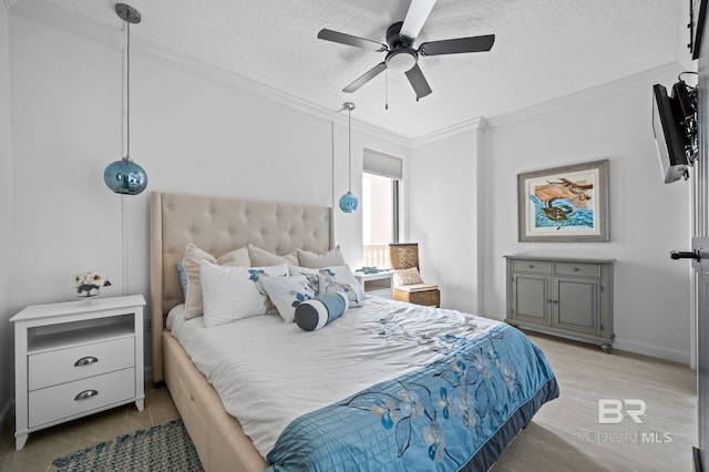 bedroom with ceiling fan, ornamental molding, a textured ceiling, and light wood-type flooring