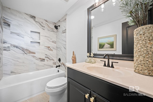 full bathroom featuring vanity, tile patterned floors, tiled shower / bath combo, toilet, and ornamental molding