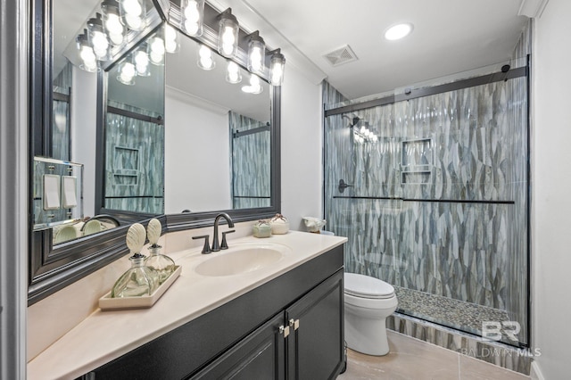 bathroom with tile patterned flooring, vanity, toilet, and a shower with shower door