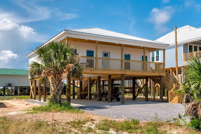 view of building exterior with stairs and a carport