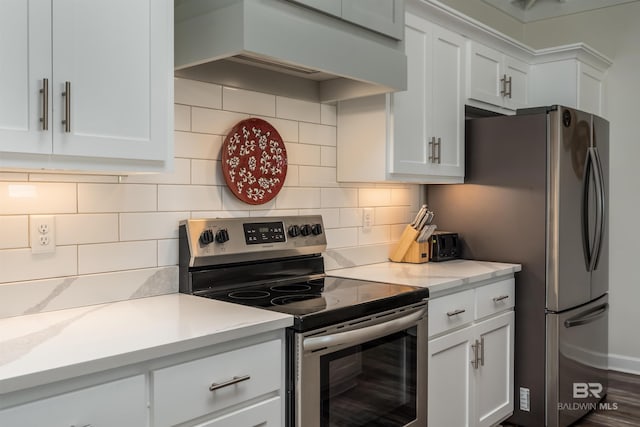 kitchen featuring appliances with stainless steel finishes, custom exhaust hood, and white cabinets