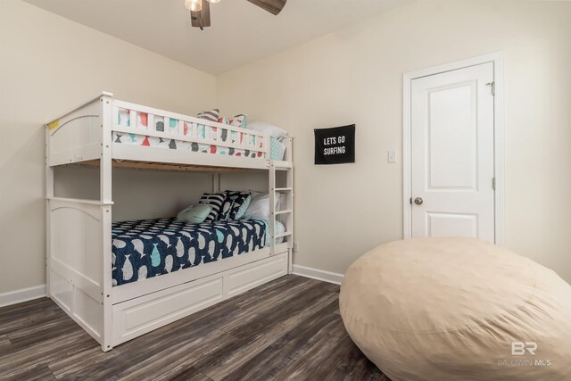 bedroom featuring dark wood-type flooring and baseboards