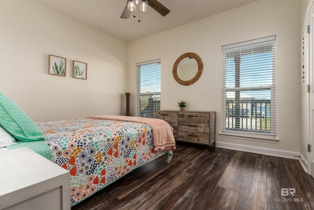 bedroom featuring wood finished floors, a ceiling fan, and baseboards