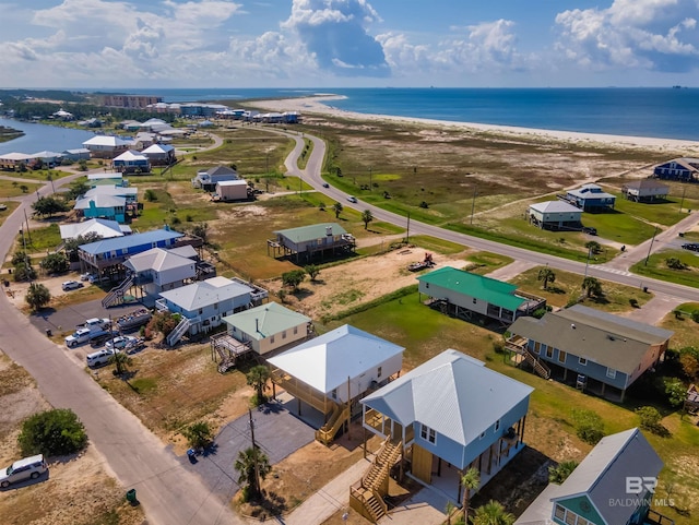 drone / aerial view featuring a water view and a view of the beach