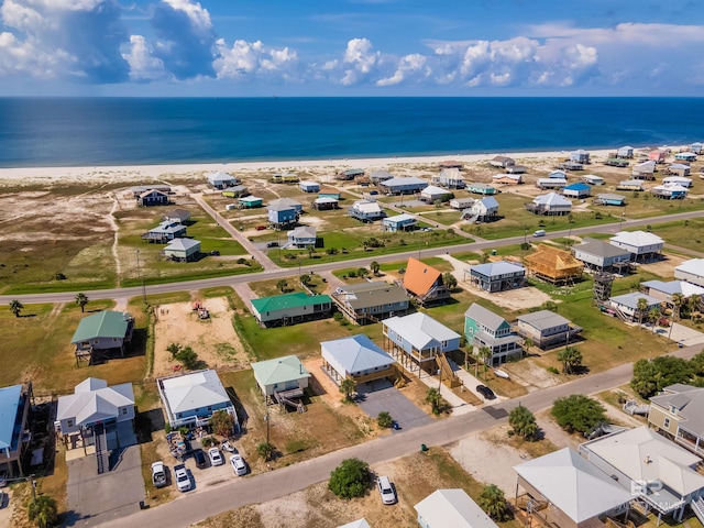 birds eye view of property featuring a water view and a beach view