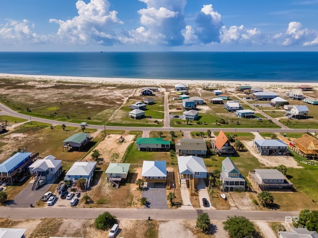 bird's eye view with a residential view, a water view, and a beach view