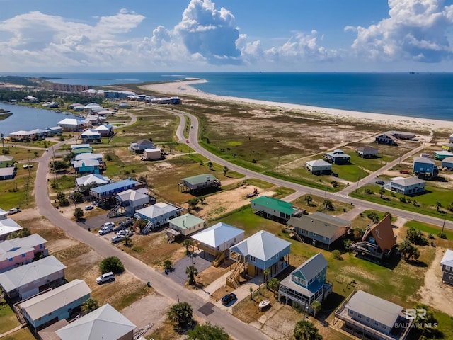 birds eye view of property with a view of the beach and a water view