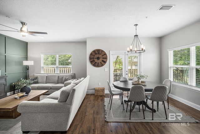 dining space with baseboards, a wealth of natural light, dark wood-style floors, and visible vents