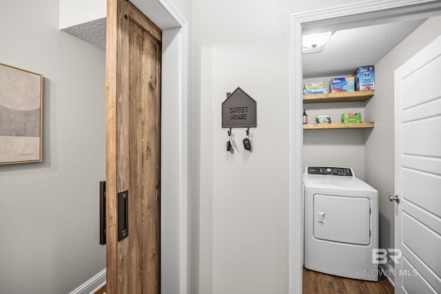 clothes washing area featuring washer / dryer, laundry area, and dark wood-style floors