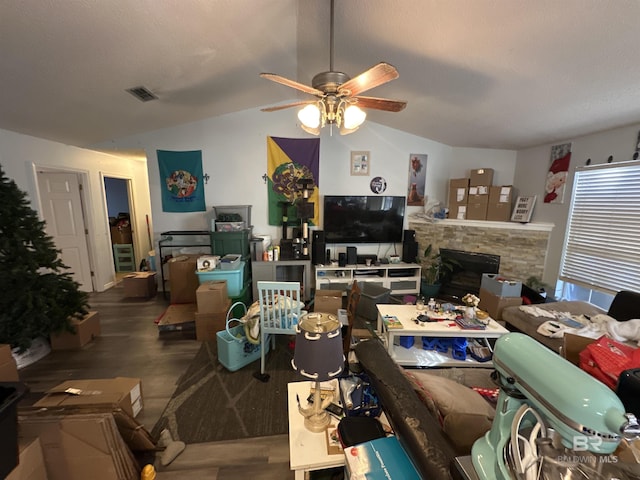 living room featuring ceiling fan and lofted ceiling