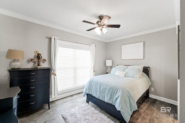 bedroom featuring ornamental molding, wood-type flooring, and ceiling fan