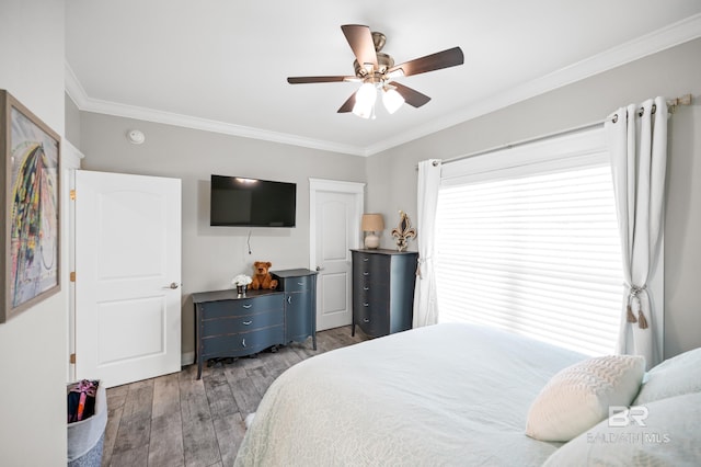 bedroom with ceiling fan, dark hardwood / wood-style floors, and crown molding