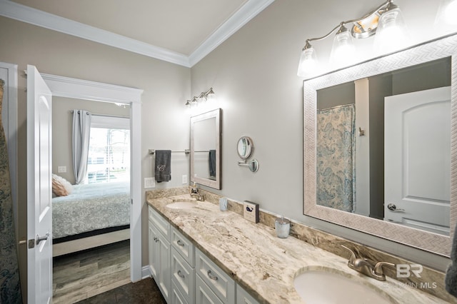 bathroom with vanity, hardwood / wood-style floors, and crown molding