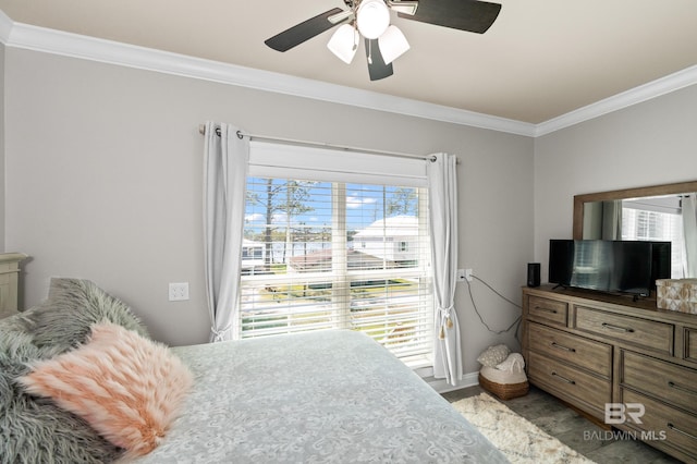 bedroom featuring multiple windows, ceiling fan, and crown molding