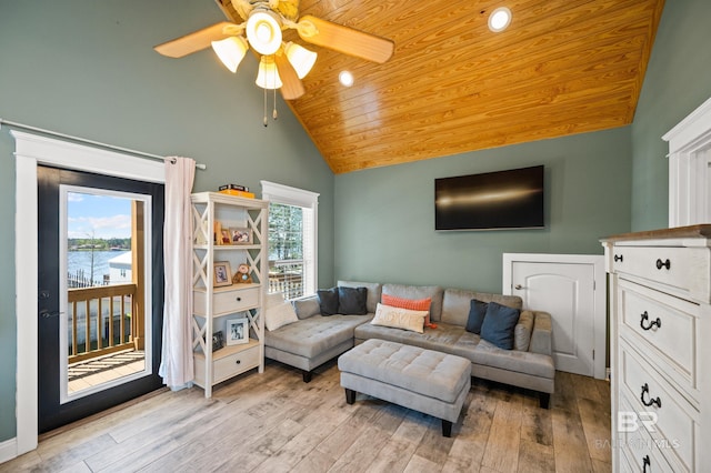 living room with light wood-type flooring, a water view, and ceiling fan