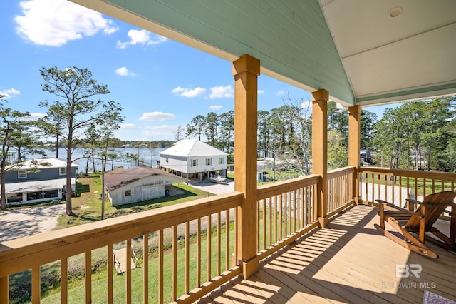 wooden deck featuring covered porch and a water view