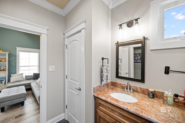 bathroom featuring hardwood / wood-style floors, vanity, and crown molding