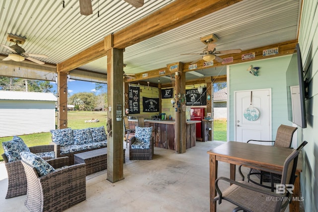 view of patio / terrace with an outbuilding, outdoor lounge area, and ceiling fan