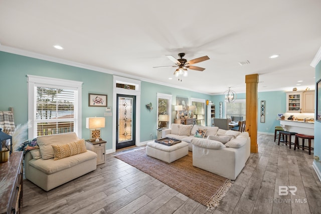 living room featuring crown molding and light hardwood / wood-style flooring