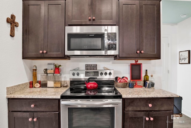 kitchen featuring appliances with stainless steel finishes and dark brown cabinets