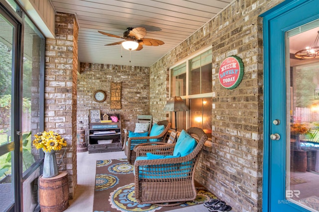 sunroom featuring ceiling fan