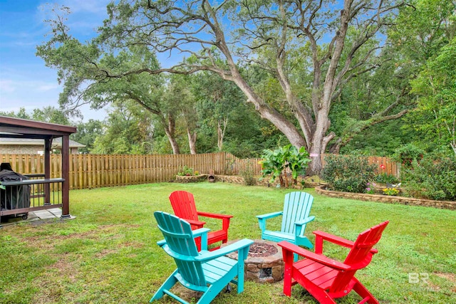 view of yard with a fire pit