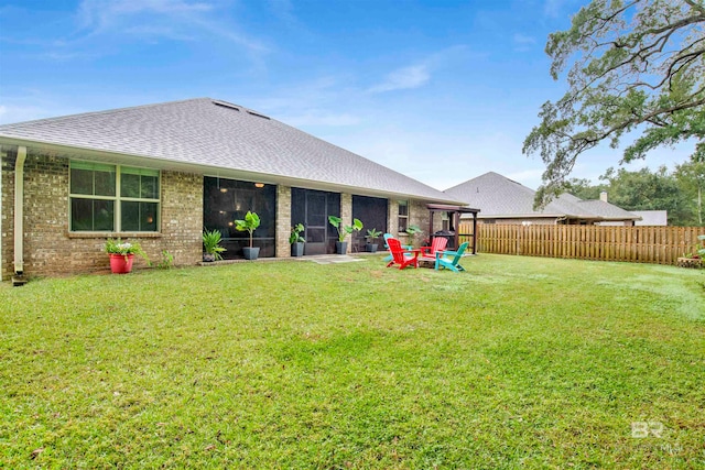 rear view of property with a patio area and a lawn