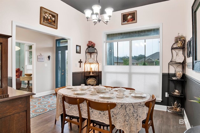 dining room with an inviting chandelier and dark hardwood / wood-style floors