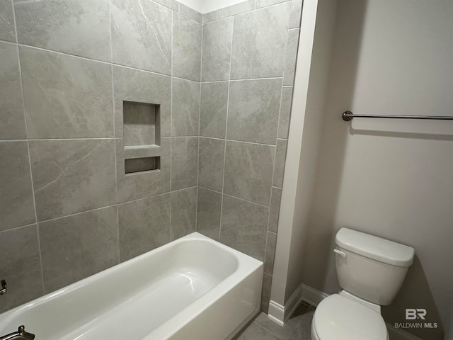 bathroom featuring tiled shower / bath and toilet