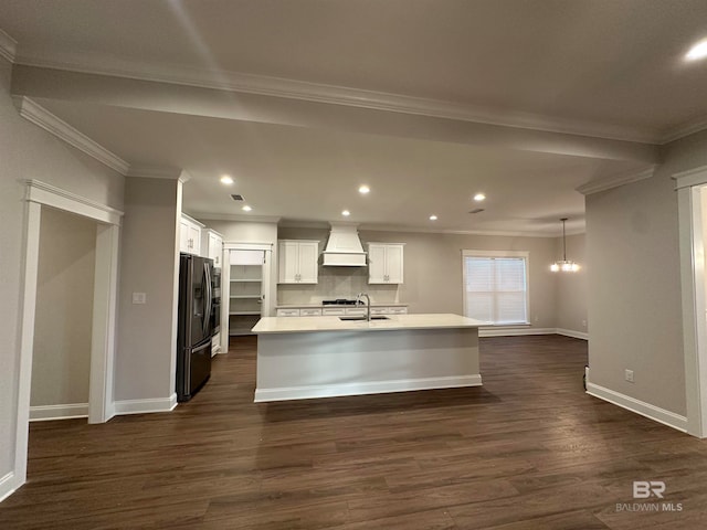 kitchen featuring a center island with sink, stainless steel fridge, dark hardwood / wood-style flooring, white cabinets, and custom exhaust hood