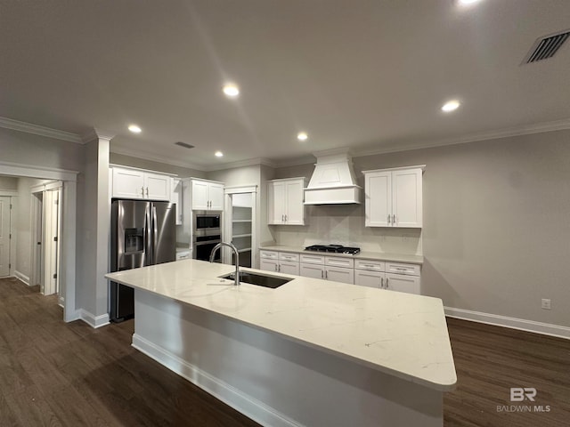 kitchen with stainless steel appliances, custom range hood, dark hardwood / wood-style floors, sink, and white cabinets