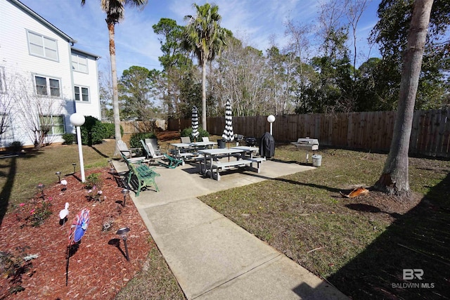 surrounding community featuring a patio area and a lawn