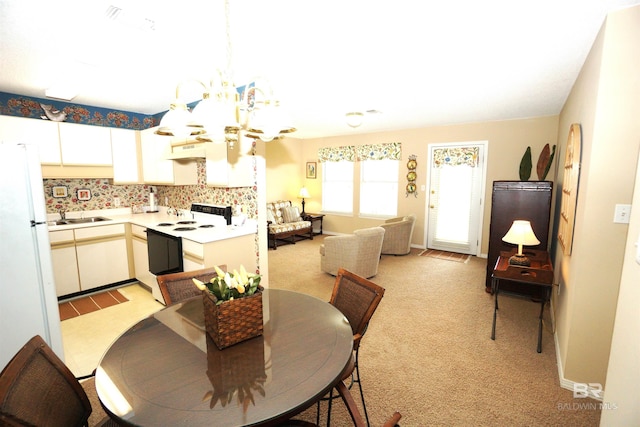 dining area featuring sink, light colored carpet, and a notable chandelier