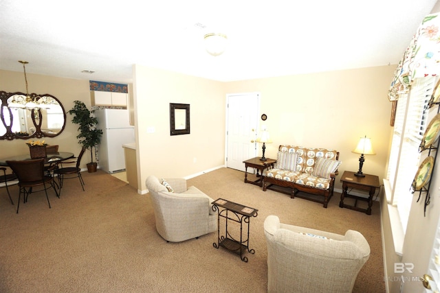 living room with a chandelier and carpet