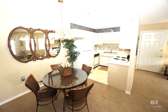 carpeted dining space featuring a notable chandelier and sink