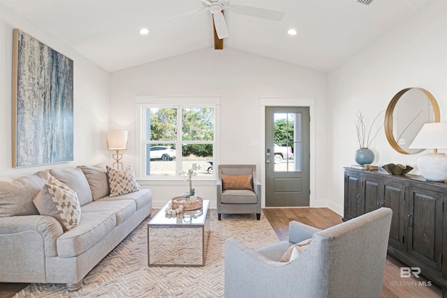 living room with ceiling fan, vaulted ceiling with beams, and light hardwood / wood-style flooring