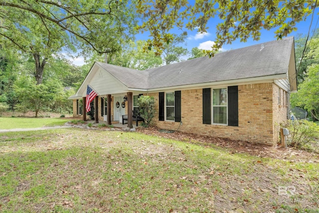 224 Cache Cir, Chickasaw, AL 36611 - single story home with brick siding, a porch, a front yard, and a shingled roof