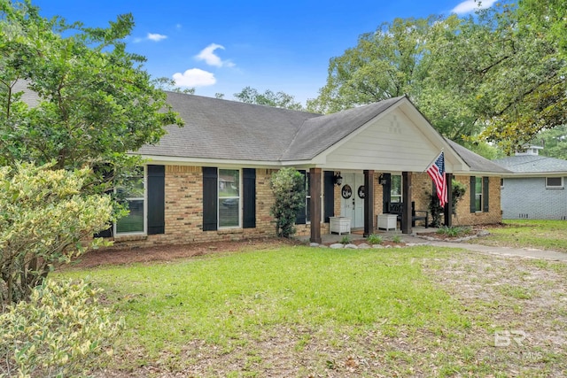 224 Cache Cir, Chickasaw, AL 36611 - ranch-style house featuring a front yard, covered porch, brick siding, and a shingled roof