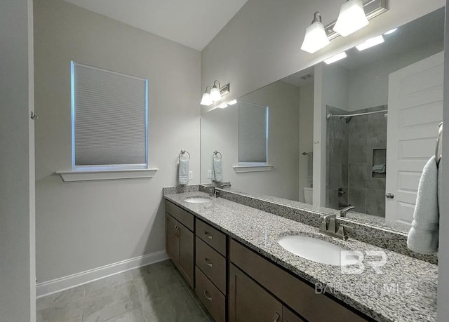 4844 E Cypress Loop, Orange Beach, AL 36561 - bathroom with toilet, a tile shower, baseboards, and double vanity