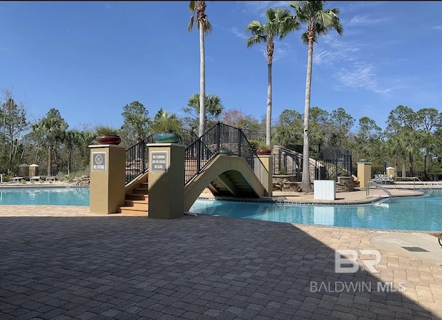 4844 E Cypress Loop, Orange Beach, AL 36561 - community pool featuring stairs and a patio